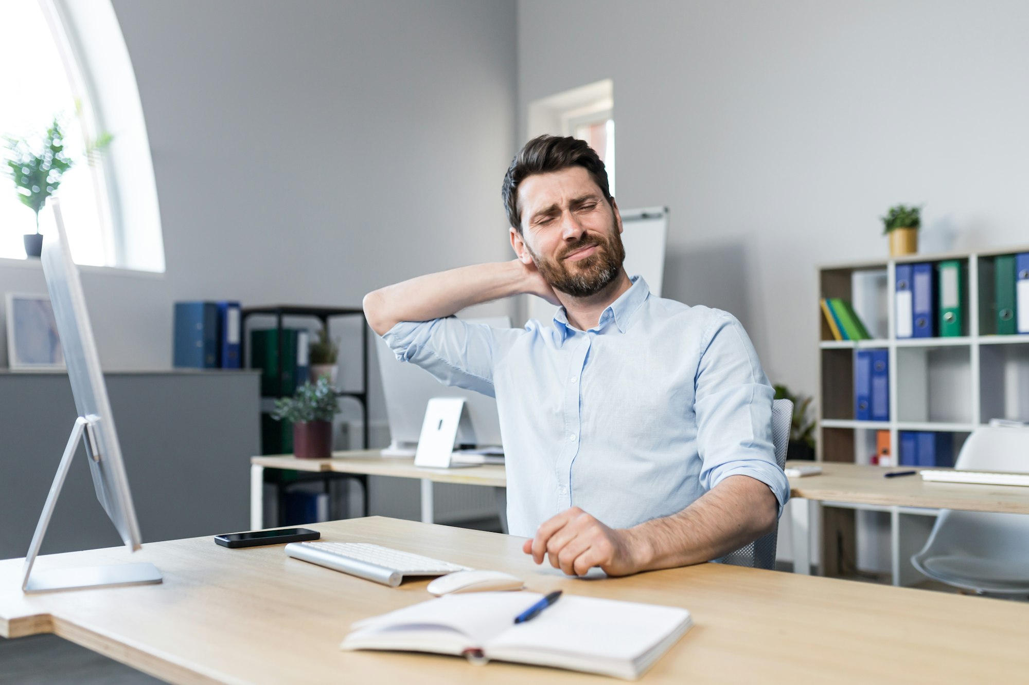 Businessman at work, tired has a severe neck pain